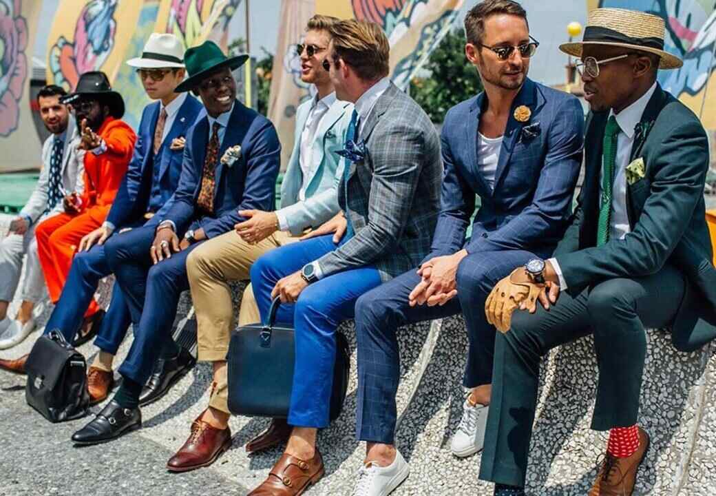 Uomini eleganti in stile italiano fotografati a un evento di moda maschile